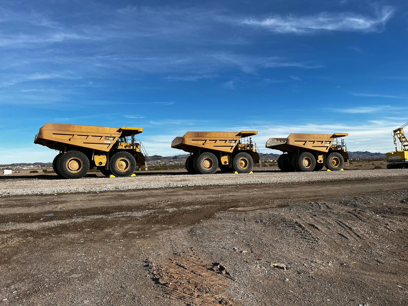 a few yellow trucks on a road